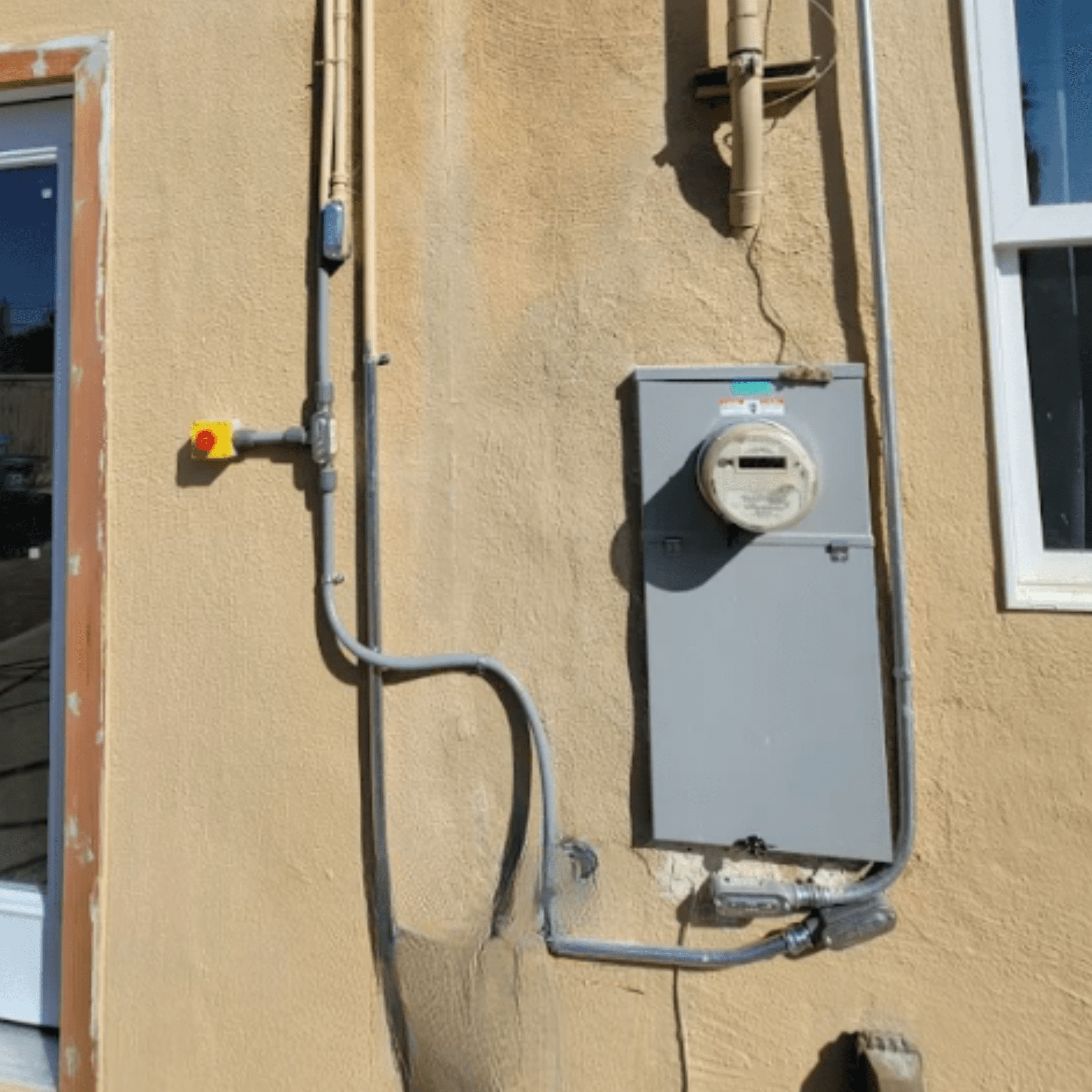 Licensed electrician inspecting a residential electrical panel before EV charger installation